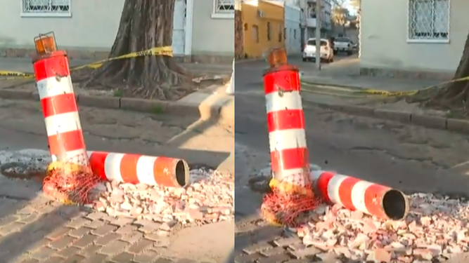 Pozo en la calle y balizas rotas.